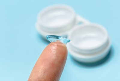 hand with contact lens